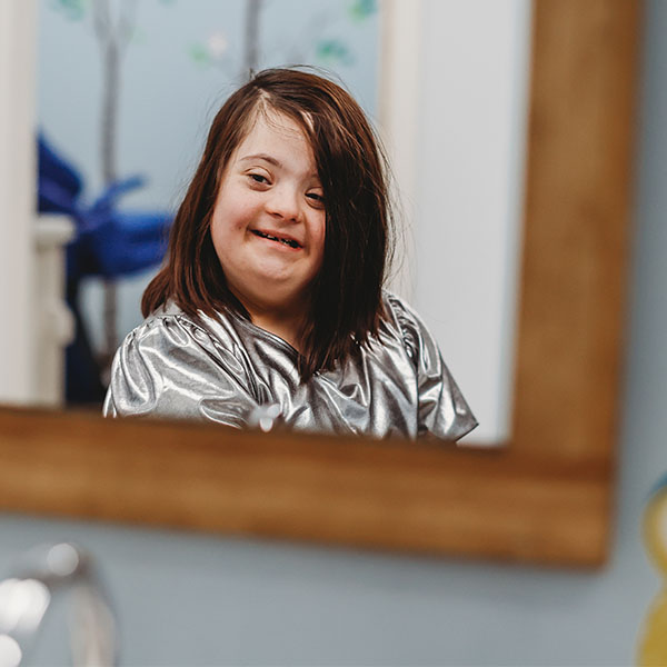 Girl making faces in the mirror